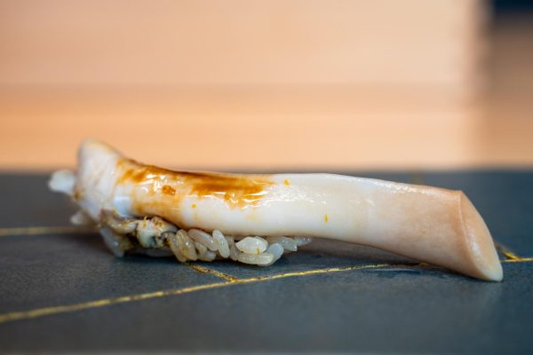Razor clam over rice in brown sauce.