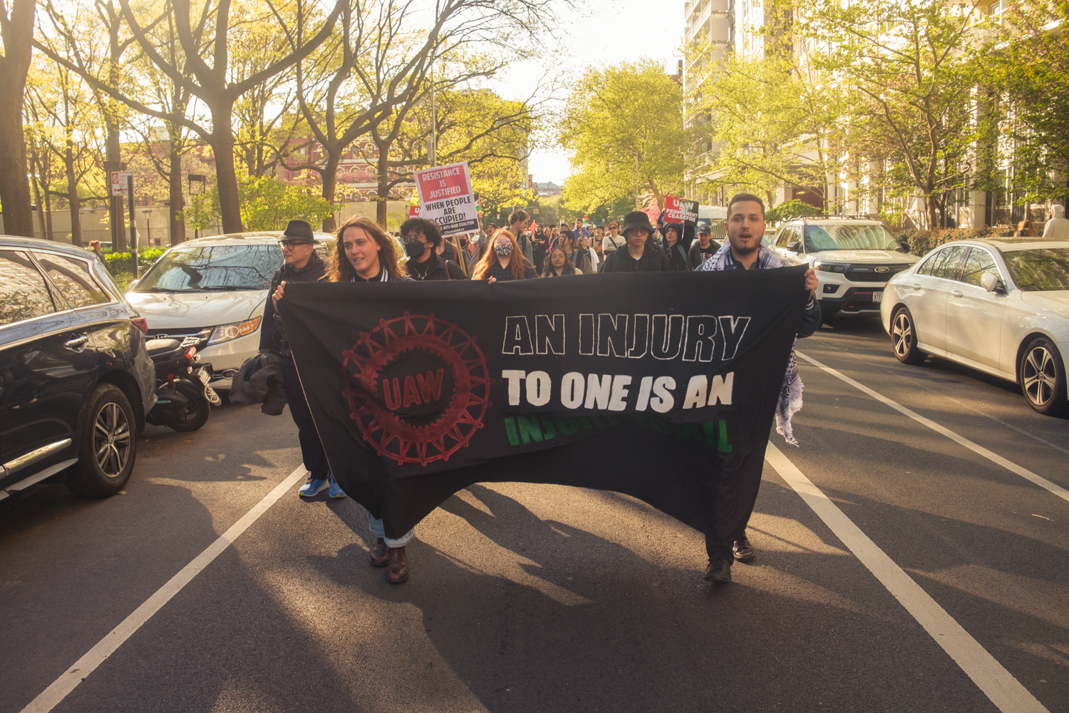 Participants of a protest organized by G.S.O.C. march down Bleecker Street toward the Paulson encampment.