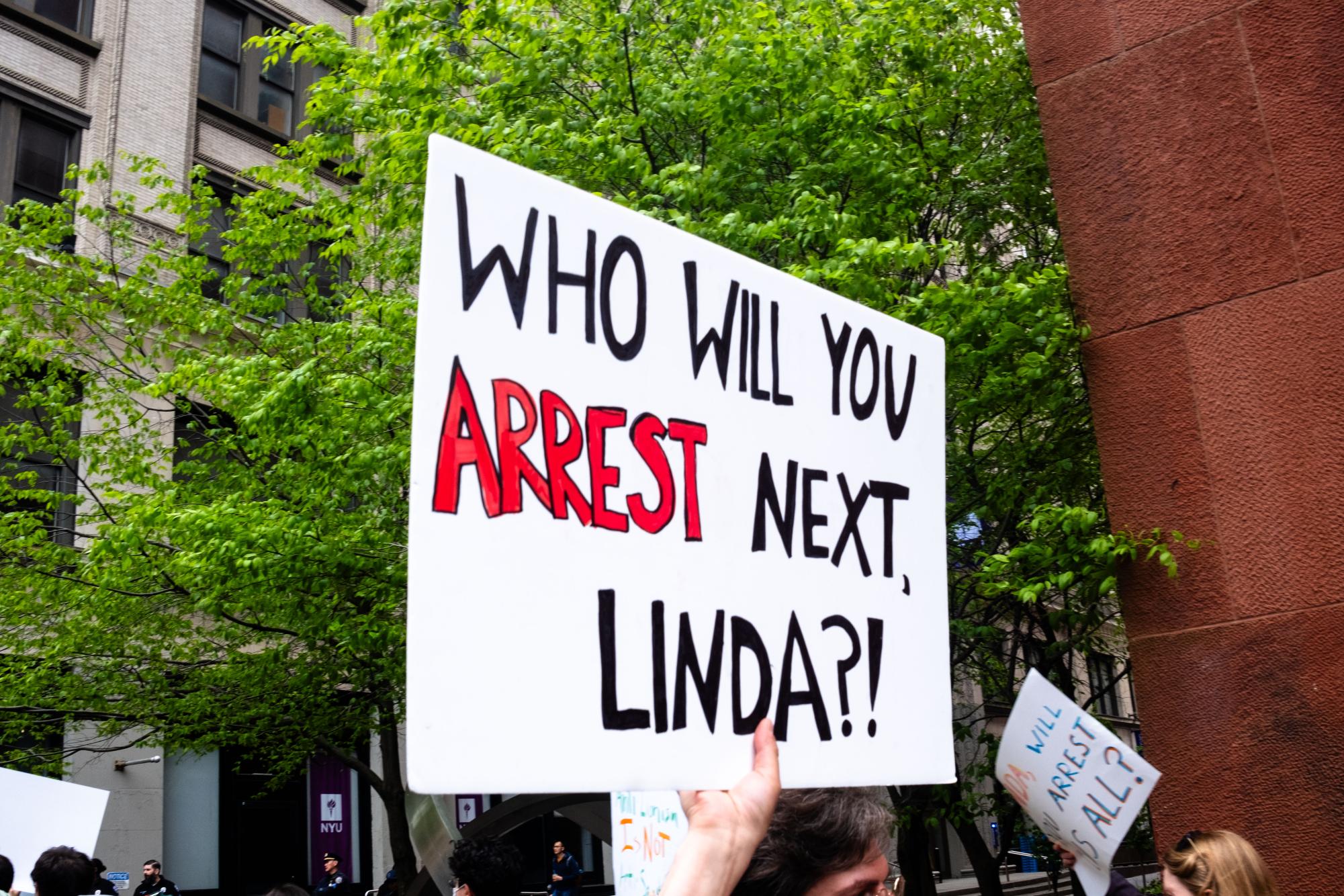 A sign that reads “Who will you arrest next, Linda?”