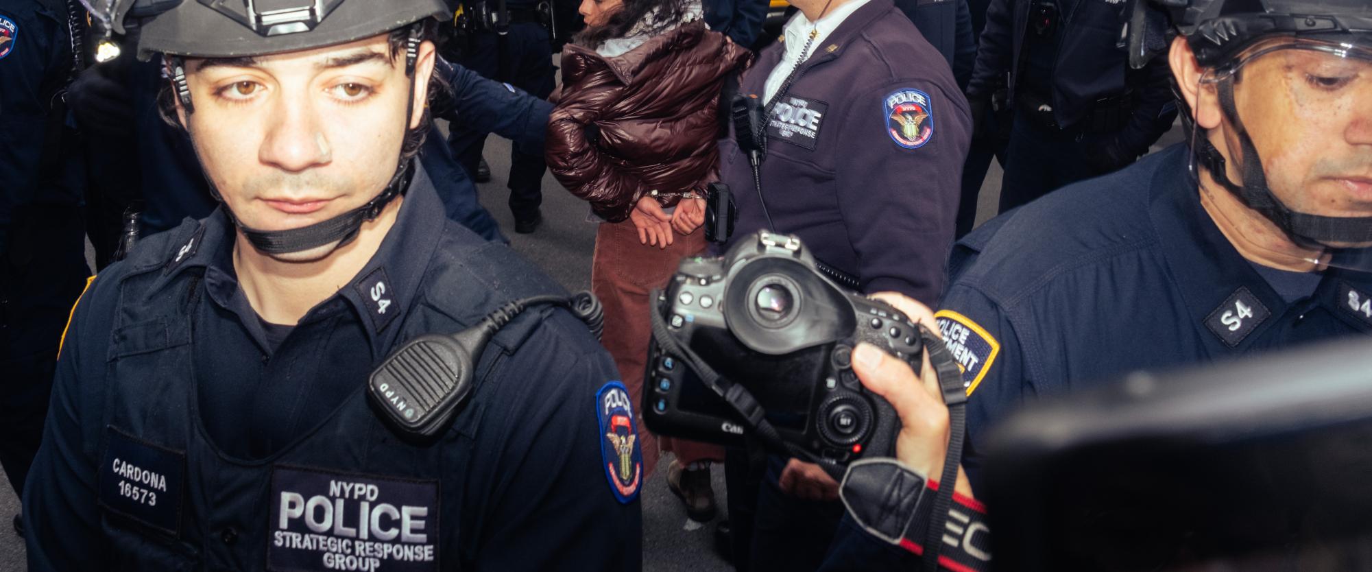 Police handcuff a protester.