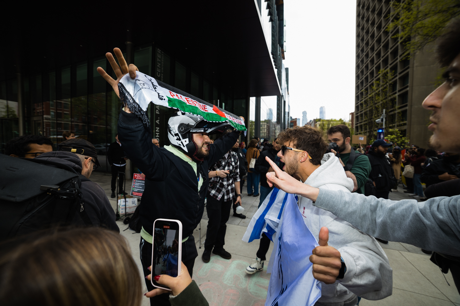 Pro-Palestinian and pro-Israeli protesters clash in front of the encampment outside the Paulson Center.