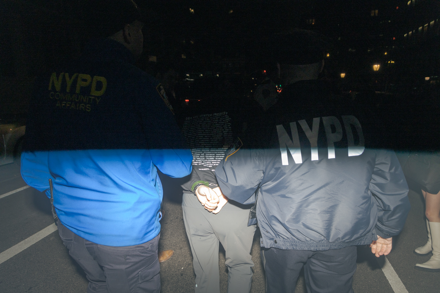 Two N.Y.P.D. officers arrest an agitator.