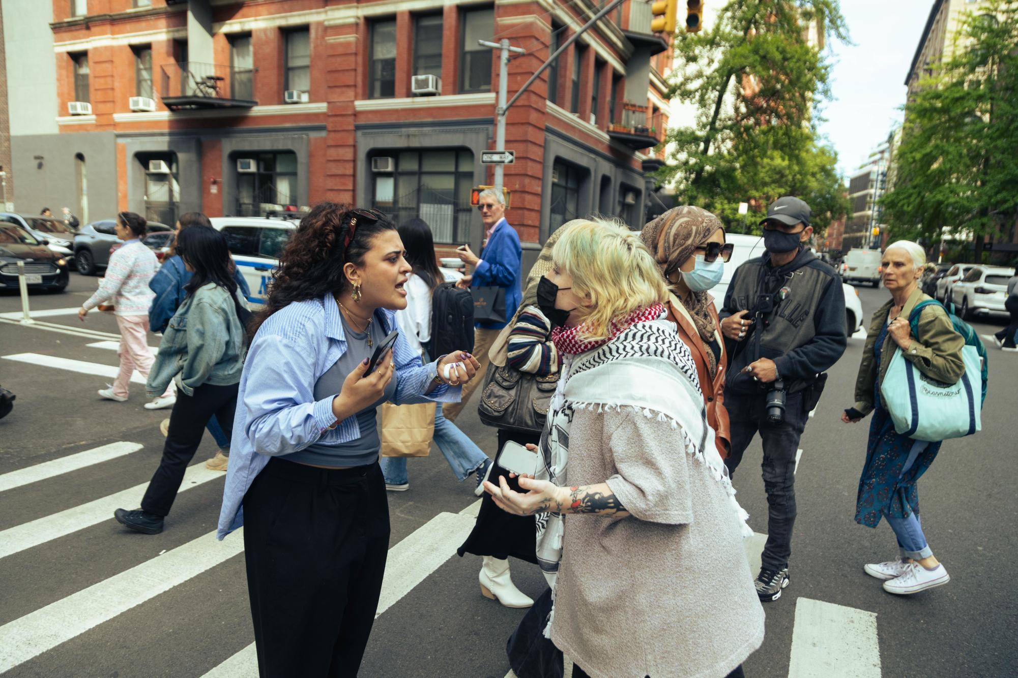 A protester and a counterprotester engage in verbal argument.