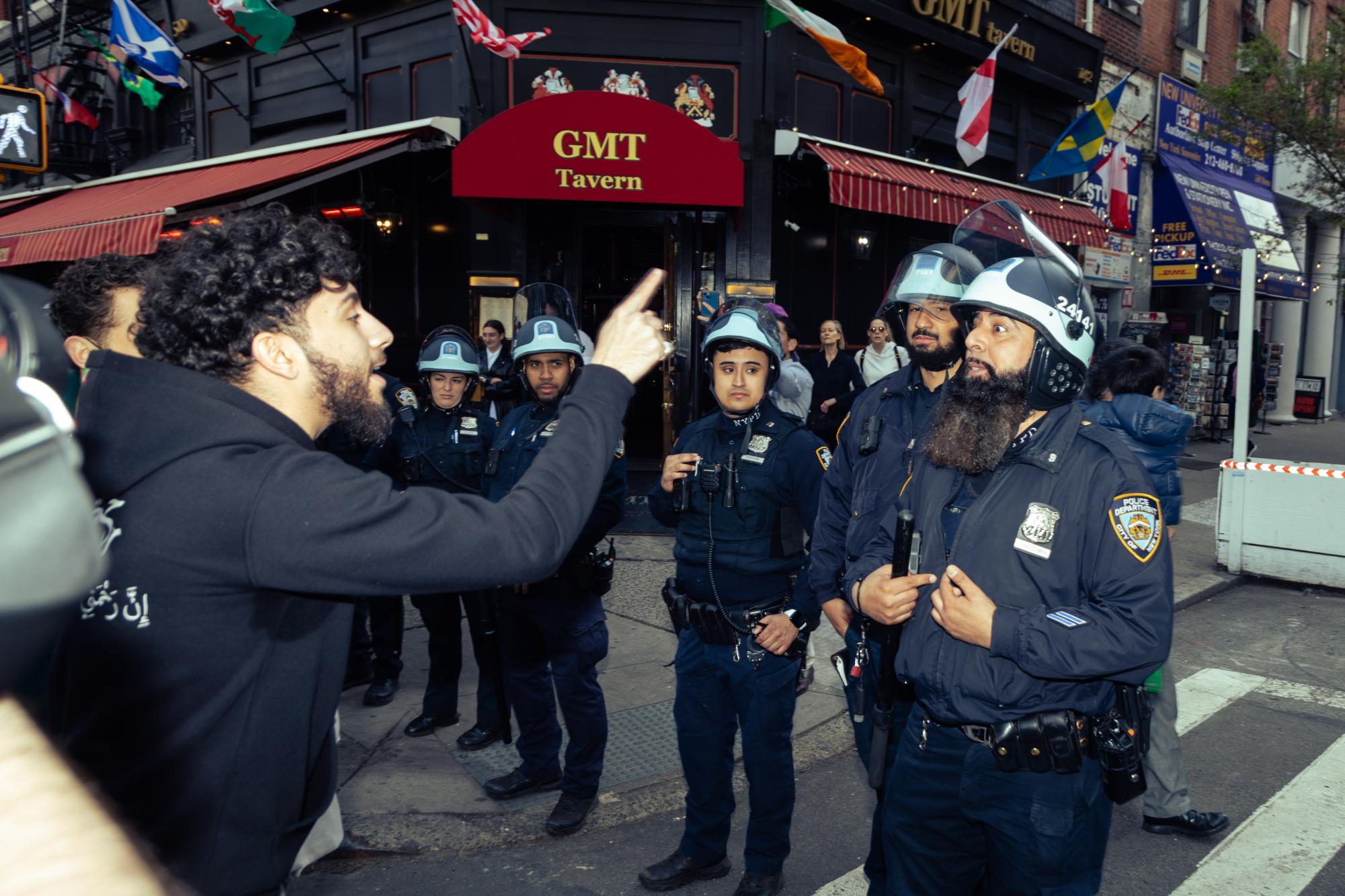 A protester confronts a police officer.