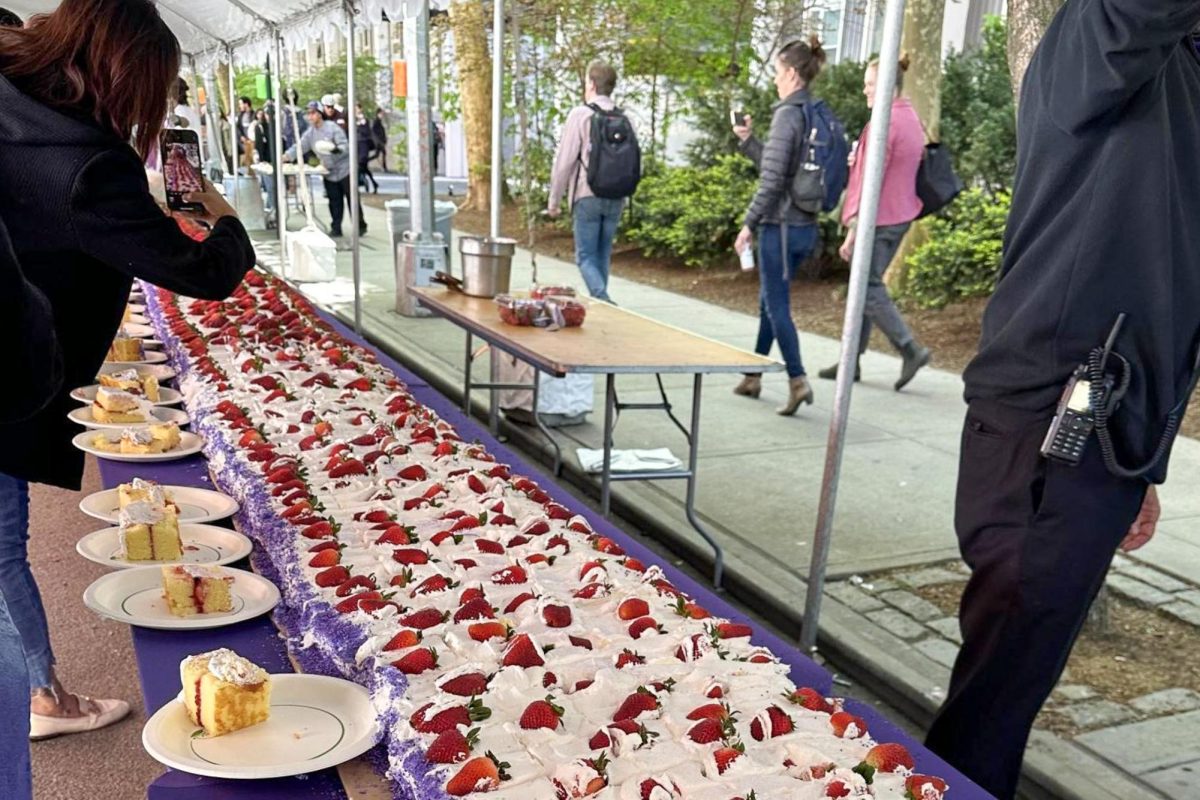 A long strawberry shortcake next to a sidewalk.