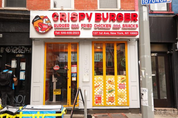 A storefront with “CRISPY BURGER” written in red lettering.