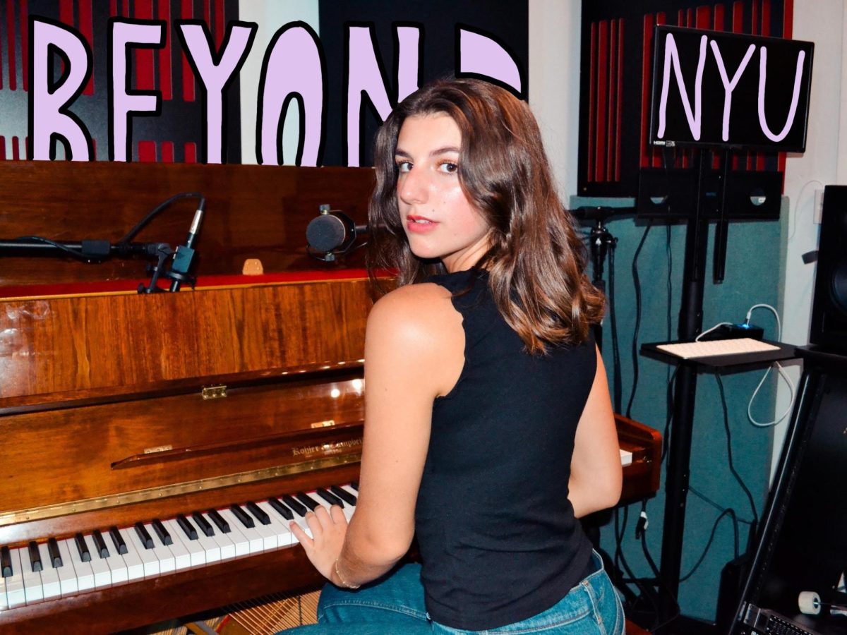 A girl sitting at a piano looks back while playing. “BEYOND” is drawn behind her and “N.Y.U.” is illustrated over a T.V. in light purple.