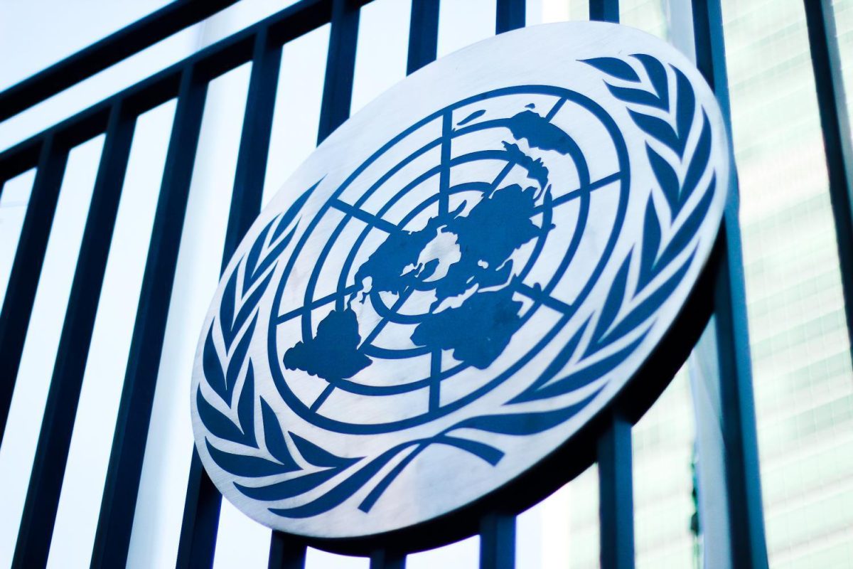 A blue and white United Nations logo on a building.