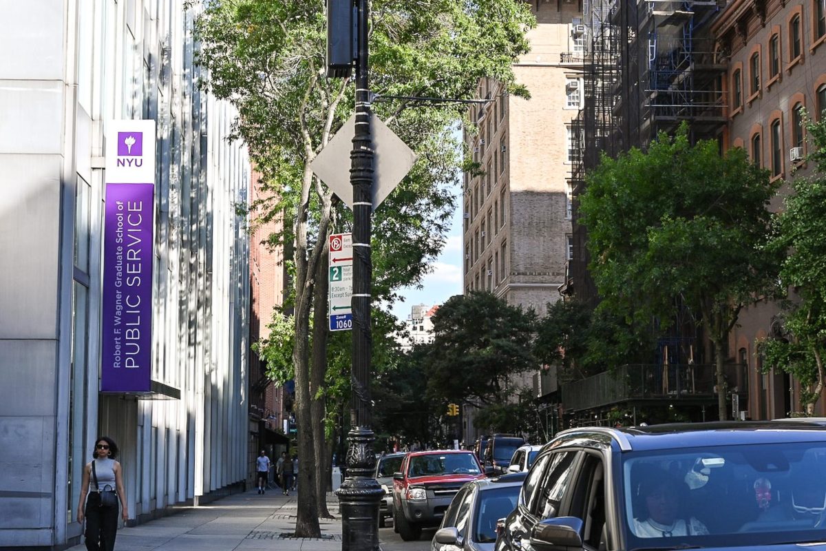 “Robert F. Wagner Graduate School of Public Service” written on a purple banner on a white building.