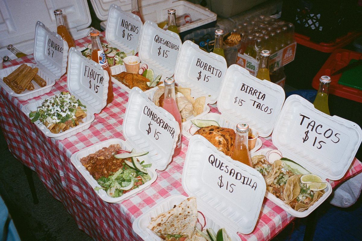 Quesadillas, tacos, burritos, a combination platter and churros lay in separate boxes with labels.