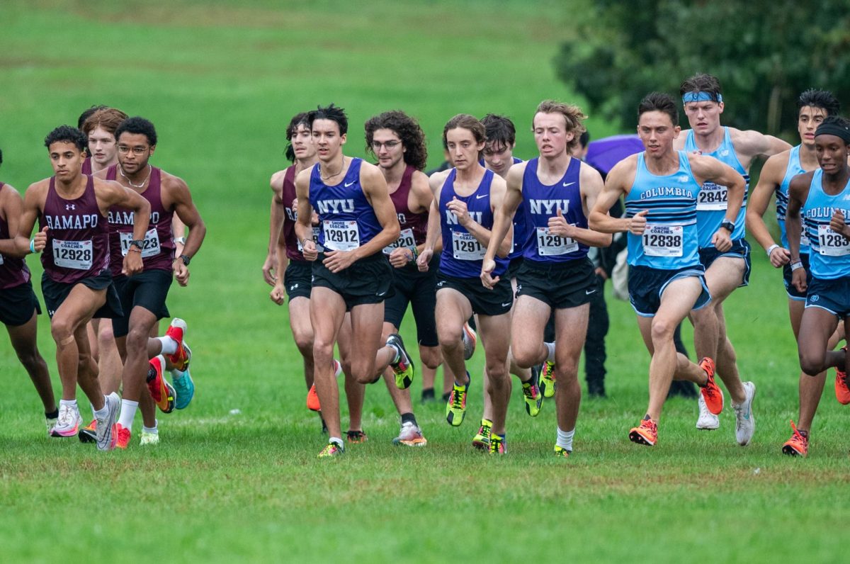 Cross-country runners compete in a grass field. Three different shirts are featured: a light blue shirt saying “Columbia,” a purple shirt saying “N.Y.U.” and a red shirt saying “Ramapo.”