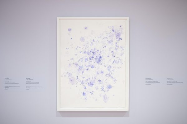 A painting with multiple purple splotches, markings and dots.