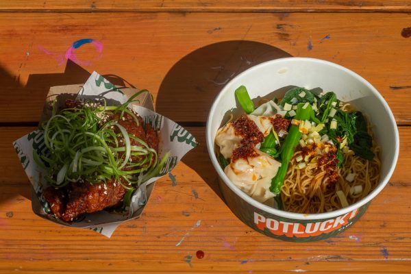 Two take-out bowls and wrapping paper that read “POTLUCK CLUB”.