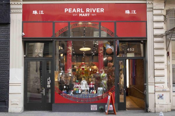 A red-and-black storefront with “Pearl River Mart” in white above the door.