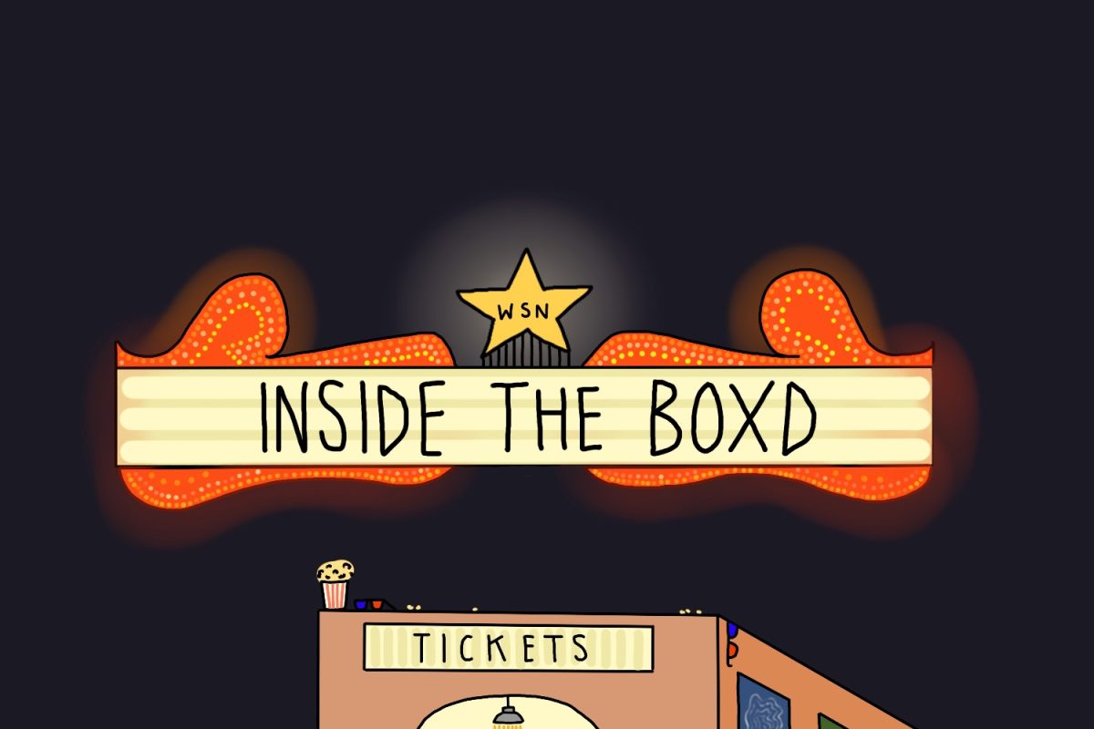 A movie ticket booth with popcorn and 3-D glasses on the roof. Above it hangs a neon sign that reads “INSIDE THE BOXD” and a star that reads “WSN”.