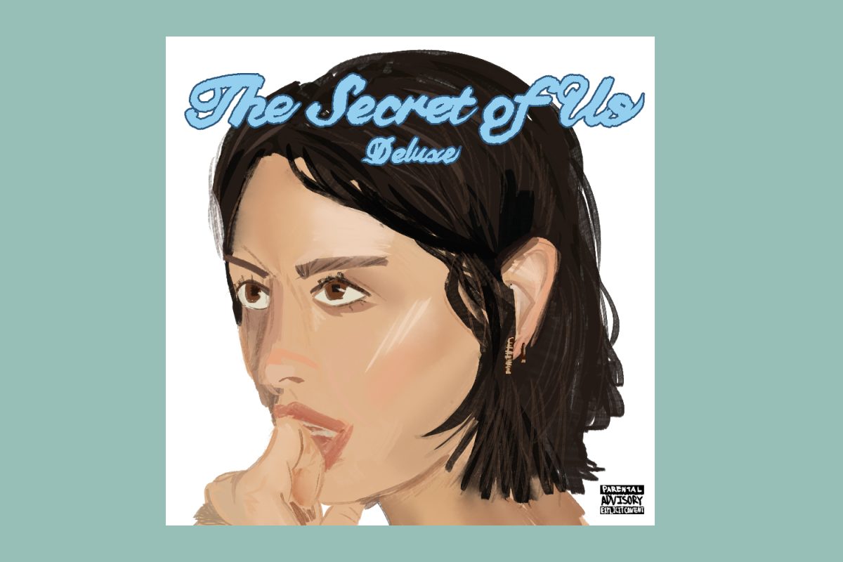 A woman with short black hair stares offscreen, her hand covering up her bottom lip. In blue cursive text reads “The Secret of Life — Deluxe” on the top half of the album cover.