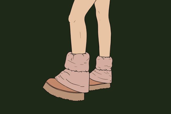 On a dark green background, a person’s legs are in frame wearing a pair of light peach boots.