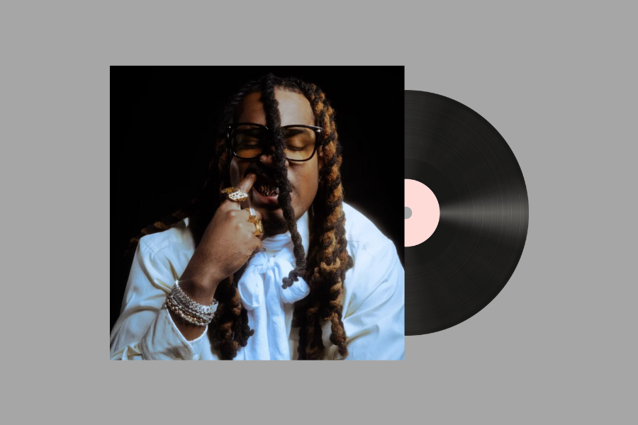 A vinyl record with a person with gold and silver accessories against a gray background.