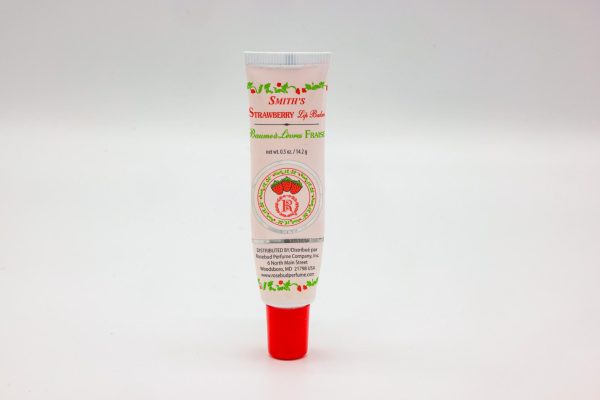 A pink lip balm tube with strawberries on the front. Red text reads “Smith’s Strawberry Lip Balm.”