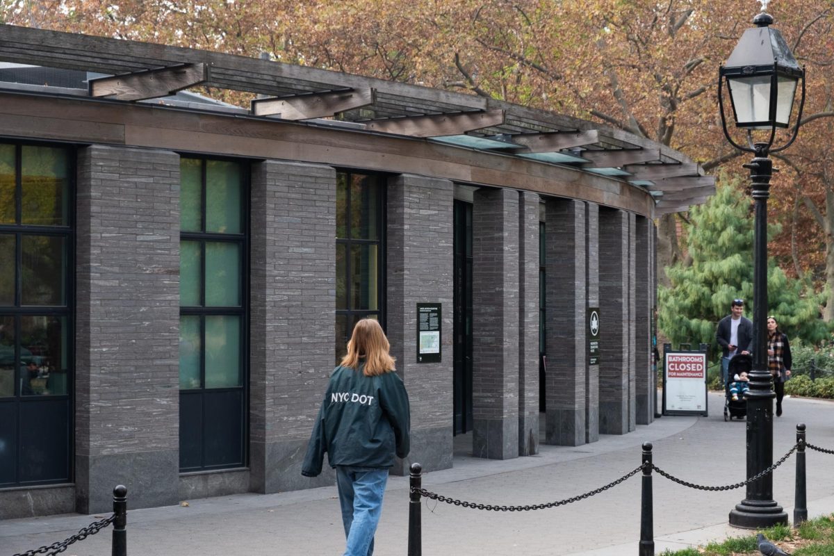 The exterior of a public restroom in a park.