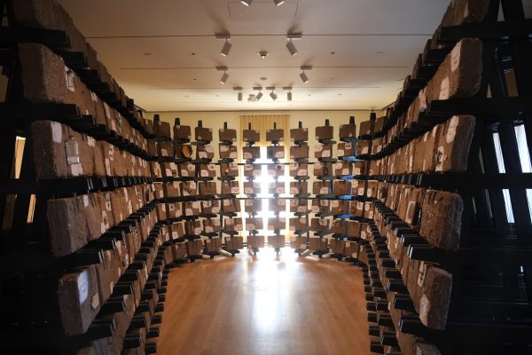 A room with stands arranged in a U shape that have labeled bricks on them.