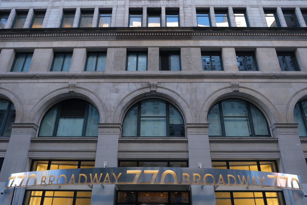 The facade of a building with arched windows and a metal awning that reads "770 Broadway."