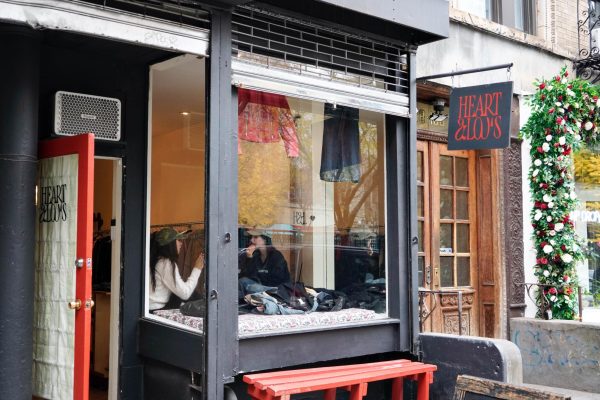 A black storefront with a red door and a red sign that reads “HEART & LOU’S.”