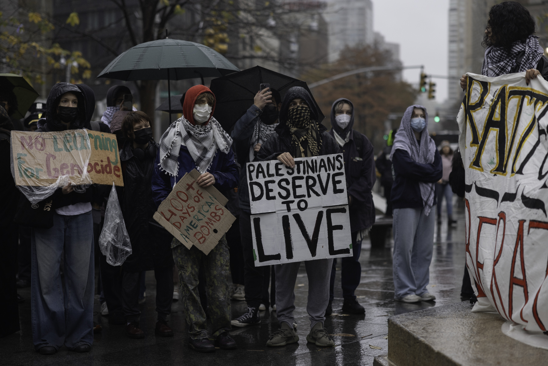 Students protest police presence on campus outside Gould Plaza wall