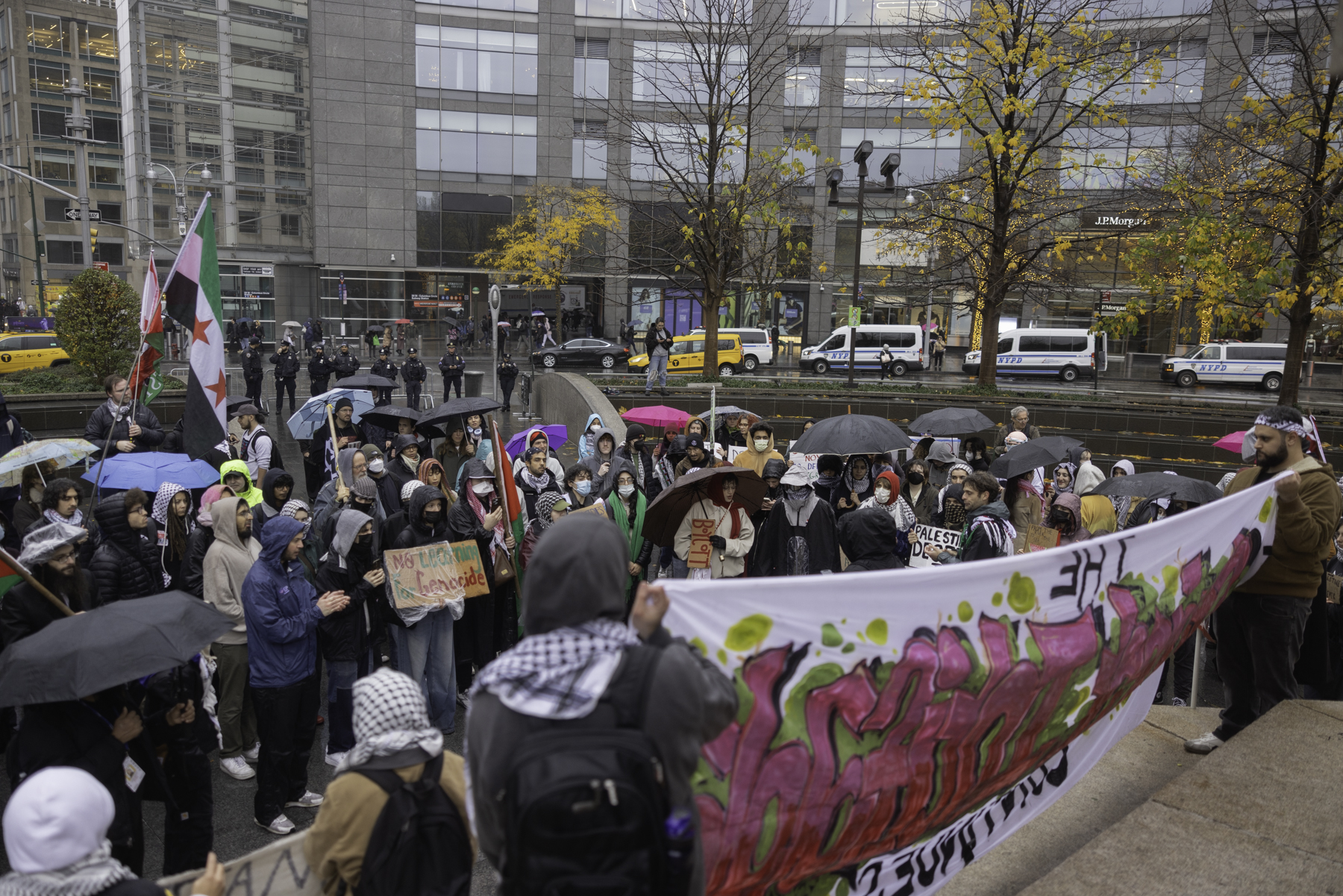 Students protest police presence on campus outside Gould Plaza wall