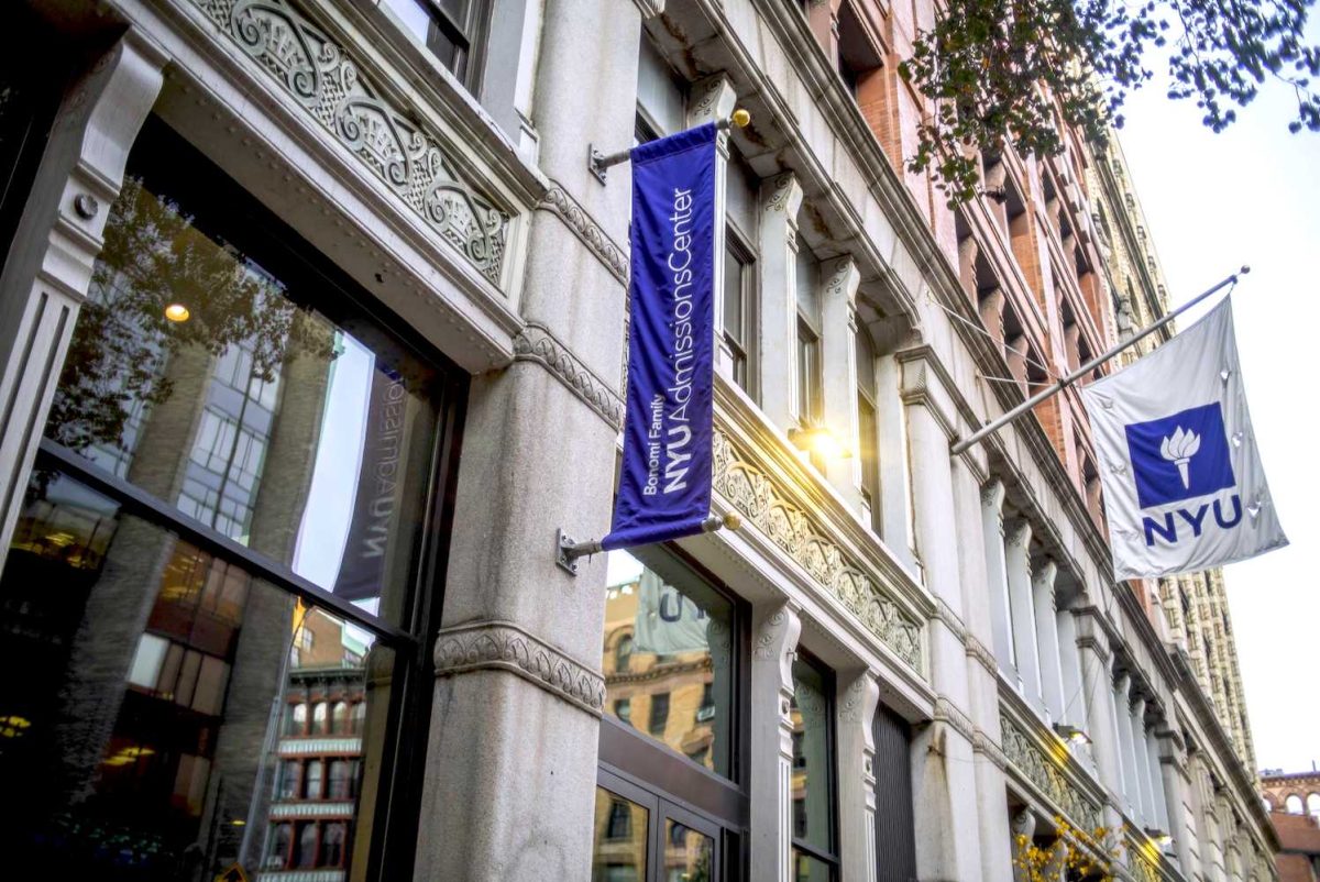 An exterior view of the N.Y.U. Bonomi Family Admissions Center. A purple flag with text that reads "Bonomi Family N.Y.U. Admissions Center."