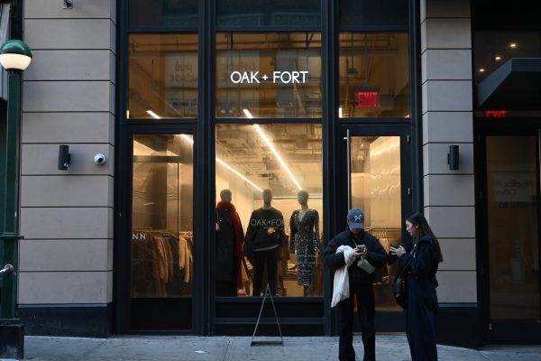 A black storefront with the words “OAK + FORT” printed on the glass.