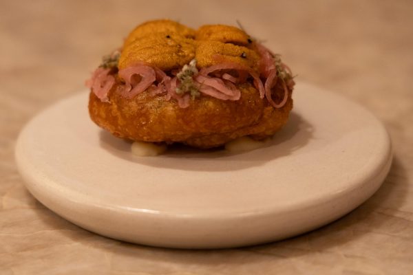 A potato cake with pickled onions and see urchin