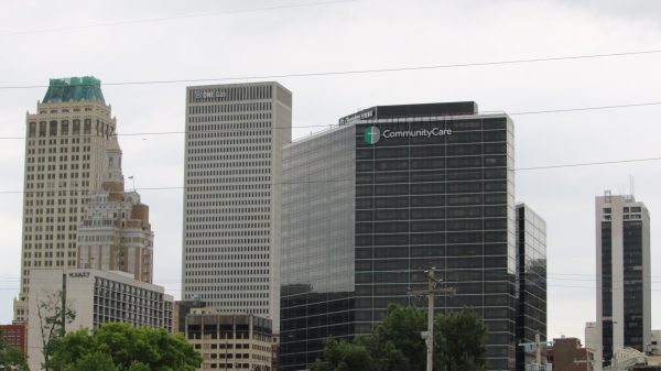 A city skyline with a building in the middle that reads “CommunityCare.”