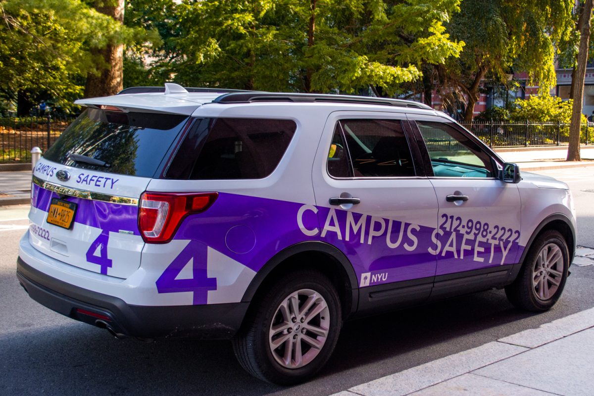 A white and purple Campus Safety vehicle.
