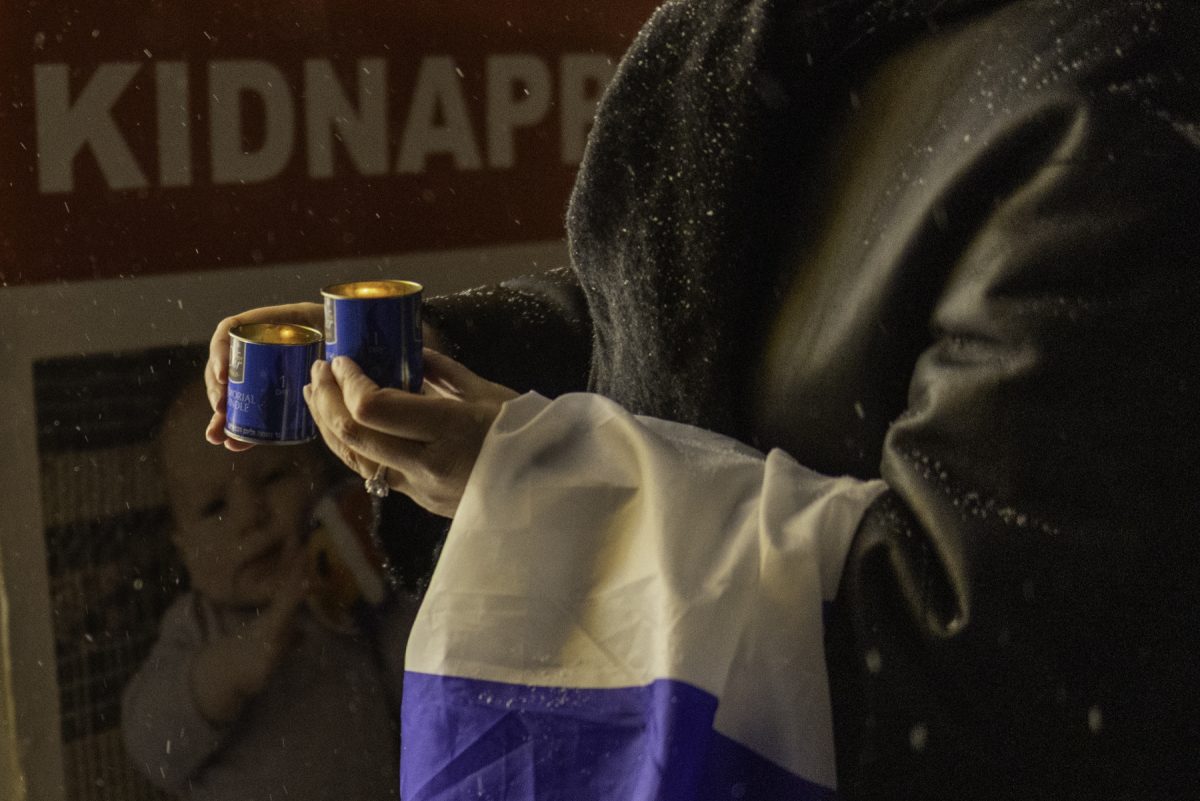 A person holds memorial candles during a vigil in Washington Square Park, Thursday, Feb. 20, 2025, in New York. (Danny Arensberg for WSN)