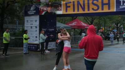 Hug (1) A mother and daughter embrace each other with a warm hug after a race in the rain. (Henry Bayha for WSN)