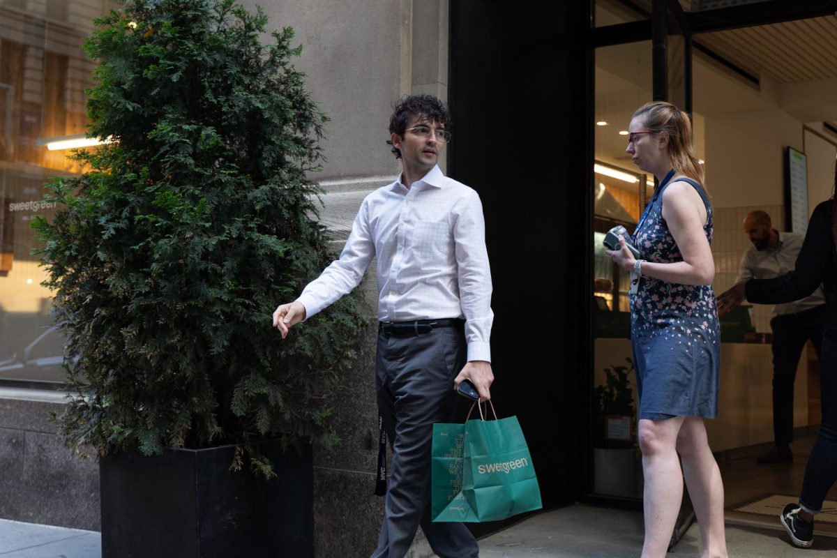 People with takeout orders walking out of sweetgreen. (Alex Woodworth for WSN)