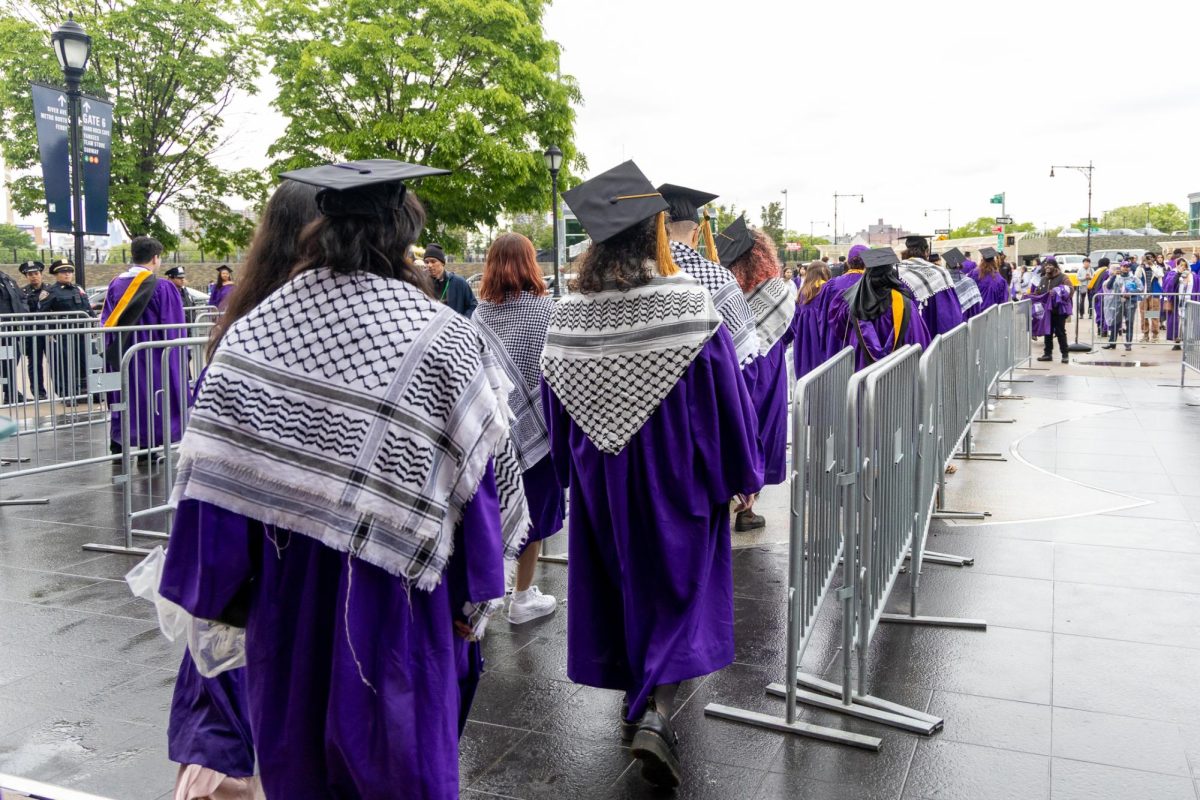 Students participate in a walk out during the 2025 commencement ceremony at Yankee Stadium. (Krish Dev for WSN)