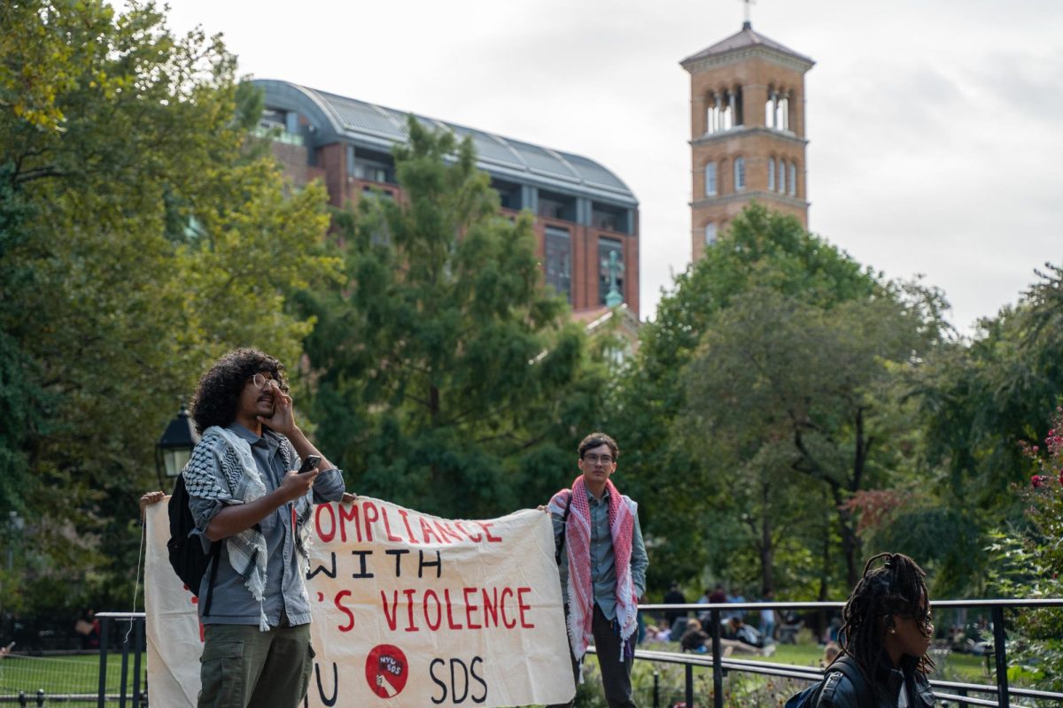 Ebtesham Ahmed leads a chant during rally in Garibaldi Plaza (Alex Woodworth for WSN)