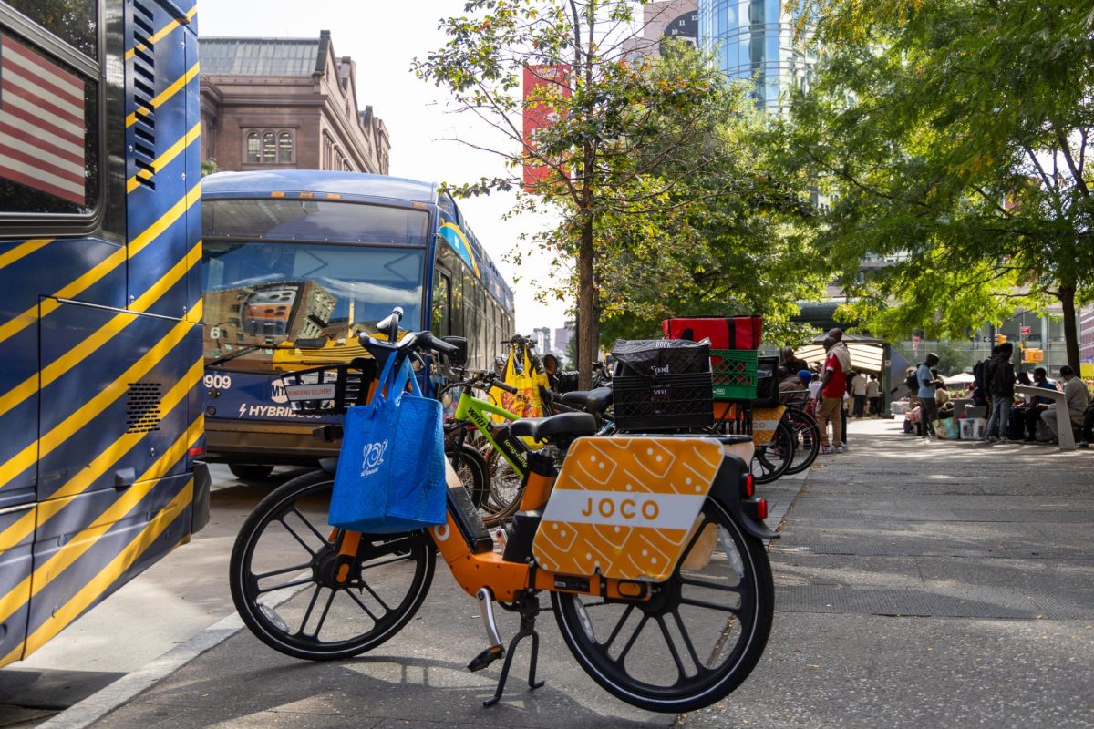 Throughout the day, delivery workers congregate outside the Astor Place subway station, a common rest stop that sits along many NYU students' walk to campus. (Krish Dev for WSN)
