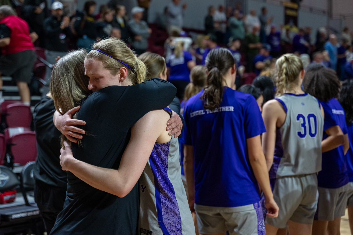Senior Caroline Peper and head coach Meg Barber embrace after NYU's Final Four loss to The University of Scranton. (Kiran Komanduri for WSN)