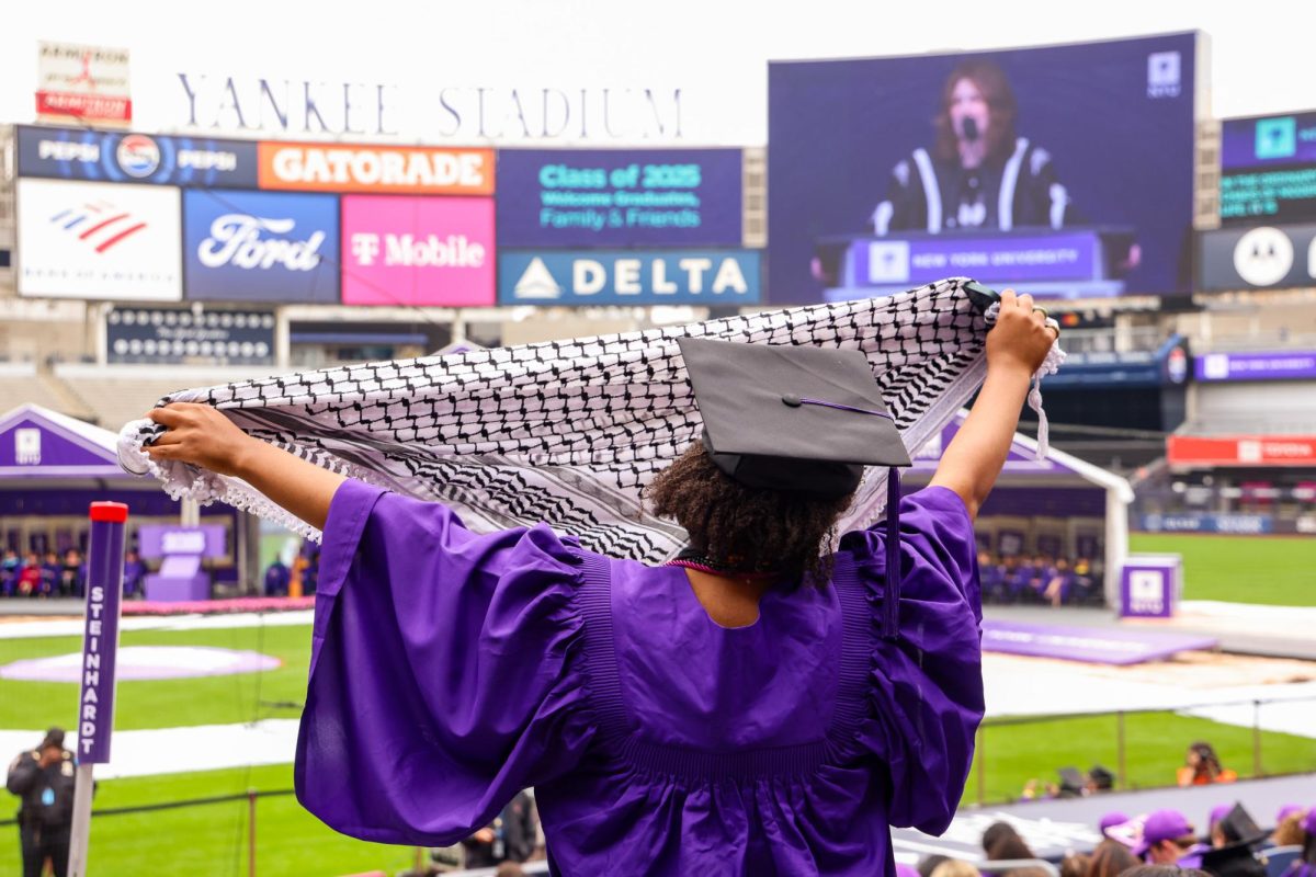 Graduates waved keffiyehs during President Linda Mills’ 2025 commencement address. (Julia Smerling for WSN)
