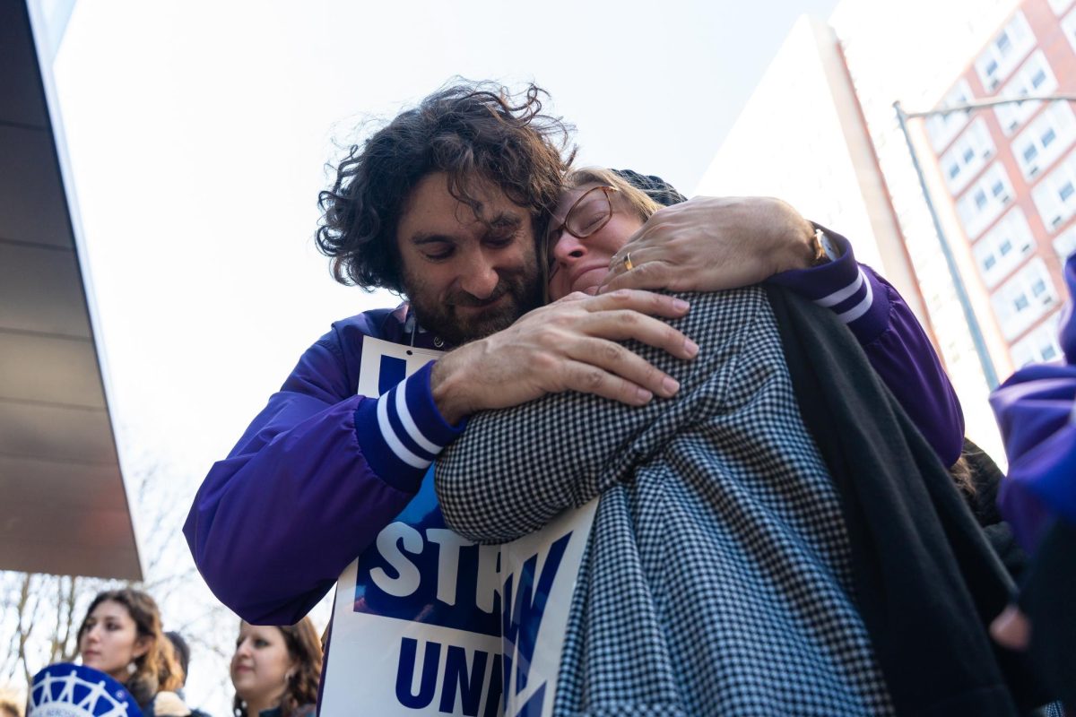 Bargaining committee member Jacob Remes embraced a contract faculty member at the end of the strike’s second day. (Alex Woodworth for WSN)
