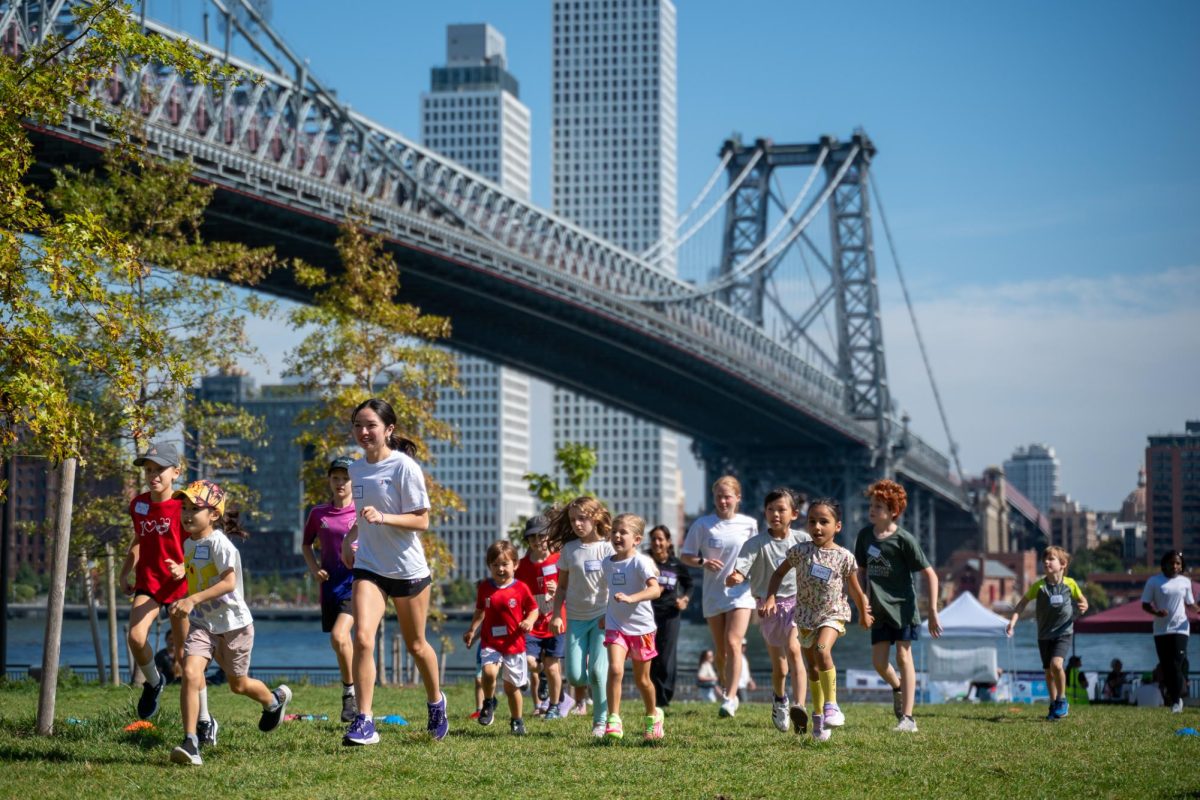 Co-president and athlete Cindy Leonard leading students at a warm-up run from last fall. (Kiran Komanduri for WSN)