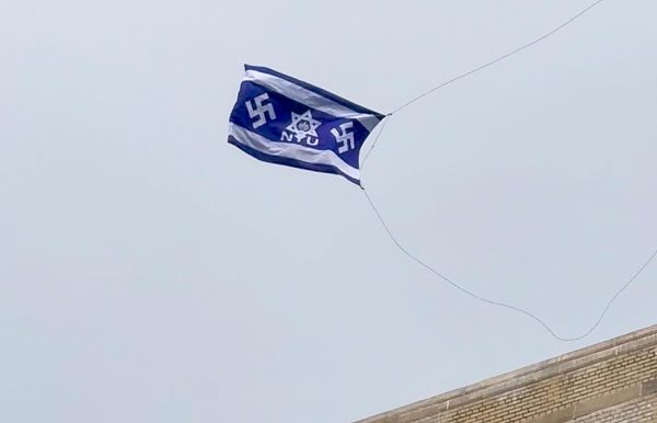 A blue flag with two swastikas, a Star of David and the letters “NYU” flies above the Steinhardt building on May 13. (Yezen Saadah for WSN)